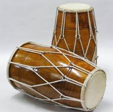 Dholak. This is a folk instrument used in Keertan, Bhajan, Sufi Islamic music and other regional styles. Some players do a lot of Tabla- or Mridangam-style  pitch bending on the bass side of the Dholak.